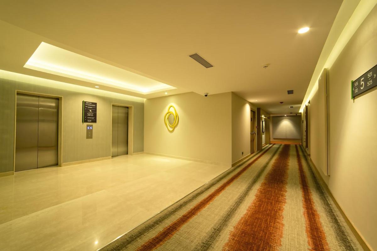 an empty hallway with a rug on the floor at Oakwood Residence Kapil Hyderabad in Hyderabad