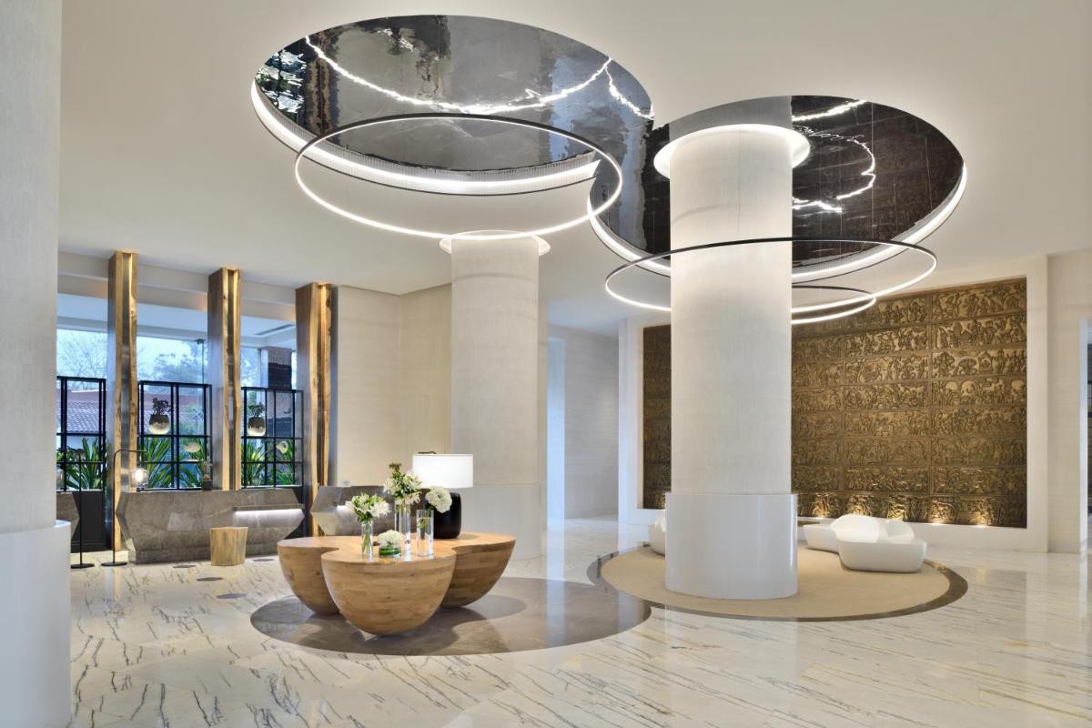 a lobby with a large chandelier in a building at The Westin Mumbai Powai Lake in Mumbai