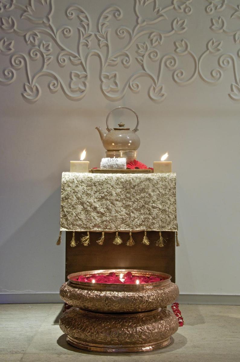a table with candles and a tea pot on top at President - IHCL SeleQtions in Mumbai