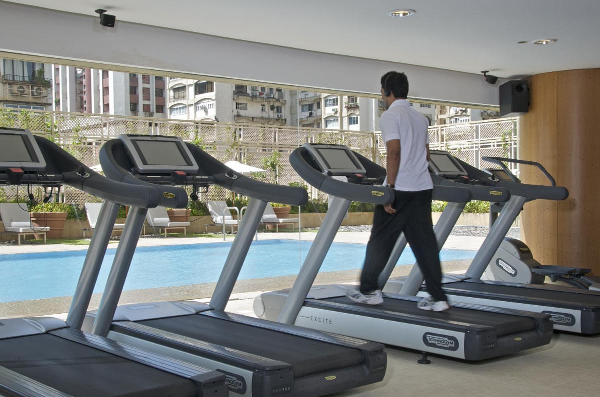 a man walking on a treadmill in a gym at President - IHCL SeleQtions in Mumbai