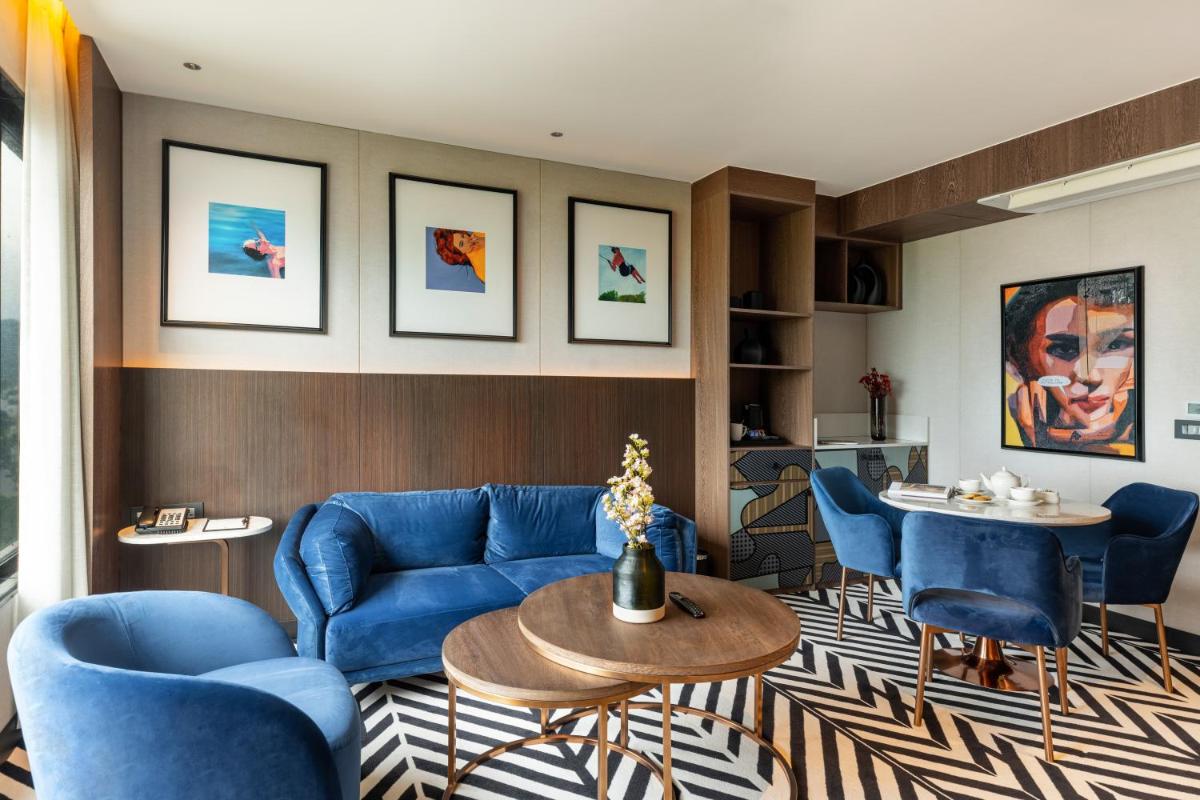 a living room with blue chairs and a table at Parallel Hotel Udaipur, a member of Radisson Individuals in Udaipur