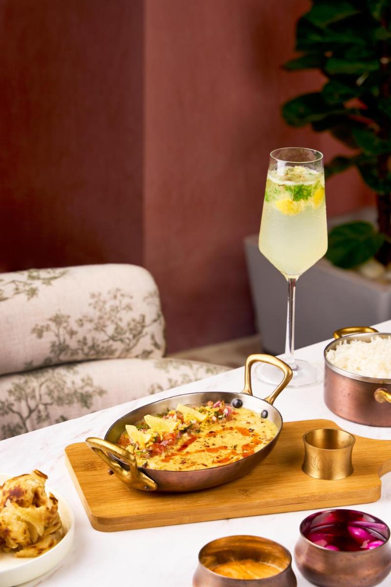 a table with a bowl of food and a glass of wine at Crowne Plaza Today Gurugram by IHG in Gurgaon