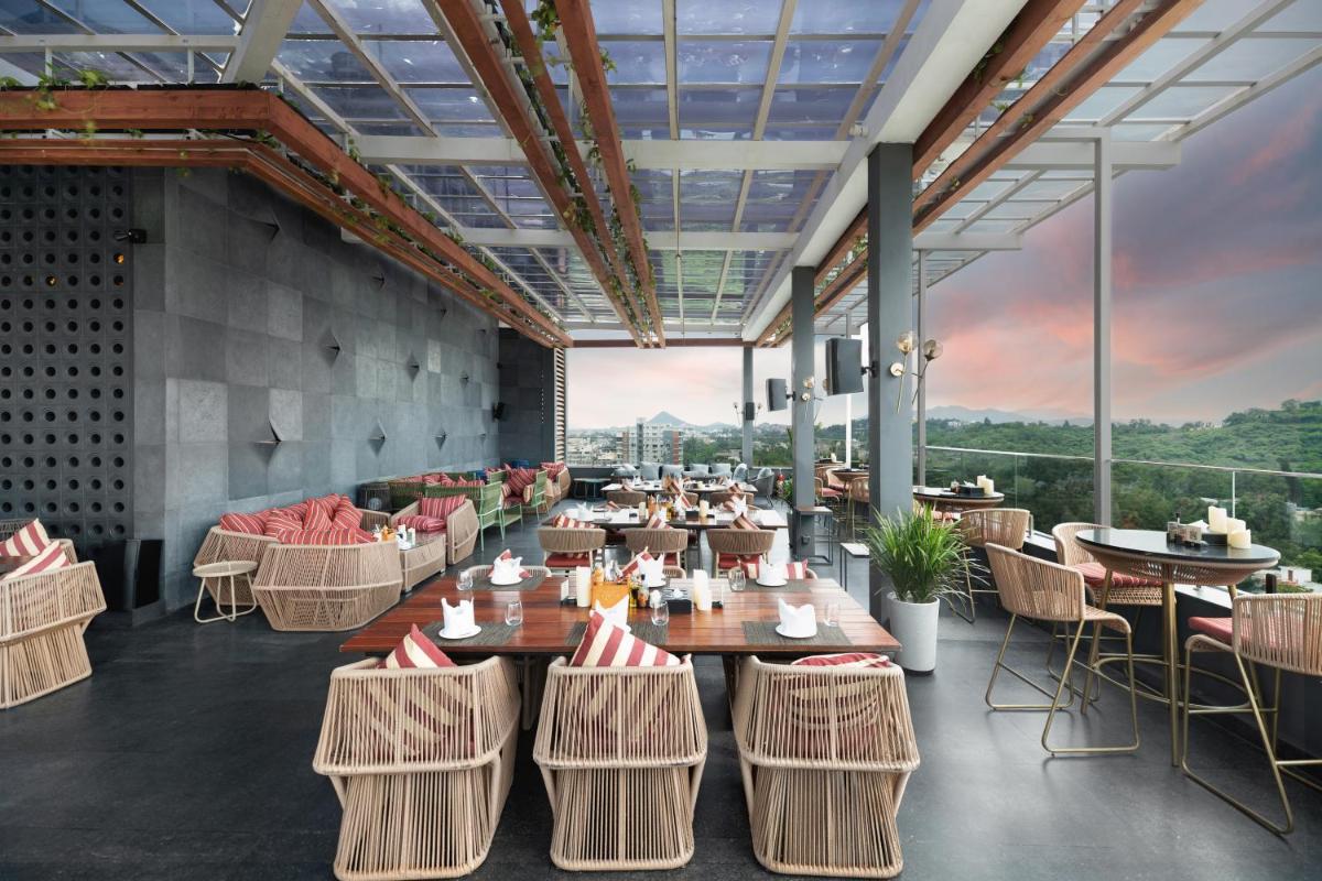 a rendering of a restaurant with tables and chairs at Parallel Hotel Udaipur, a member of Radisson Individuals in Udaipur