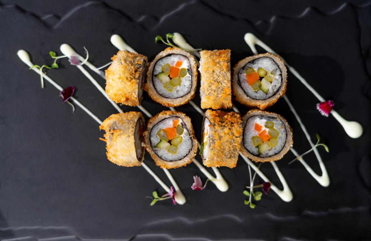 a group of sushi on skewers on a table at Parallel Hotel Udaipur, a member of Radisson Individuals in Udaipur
