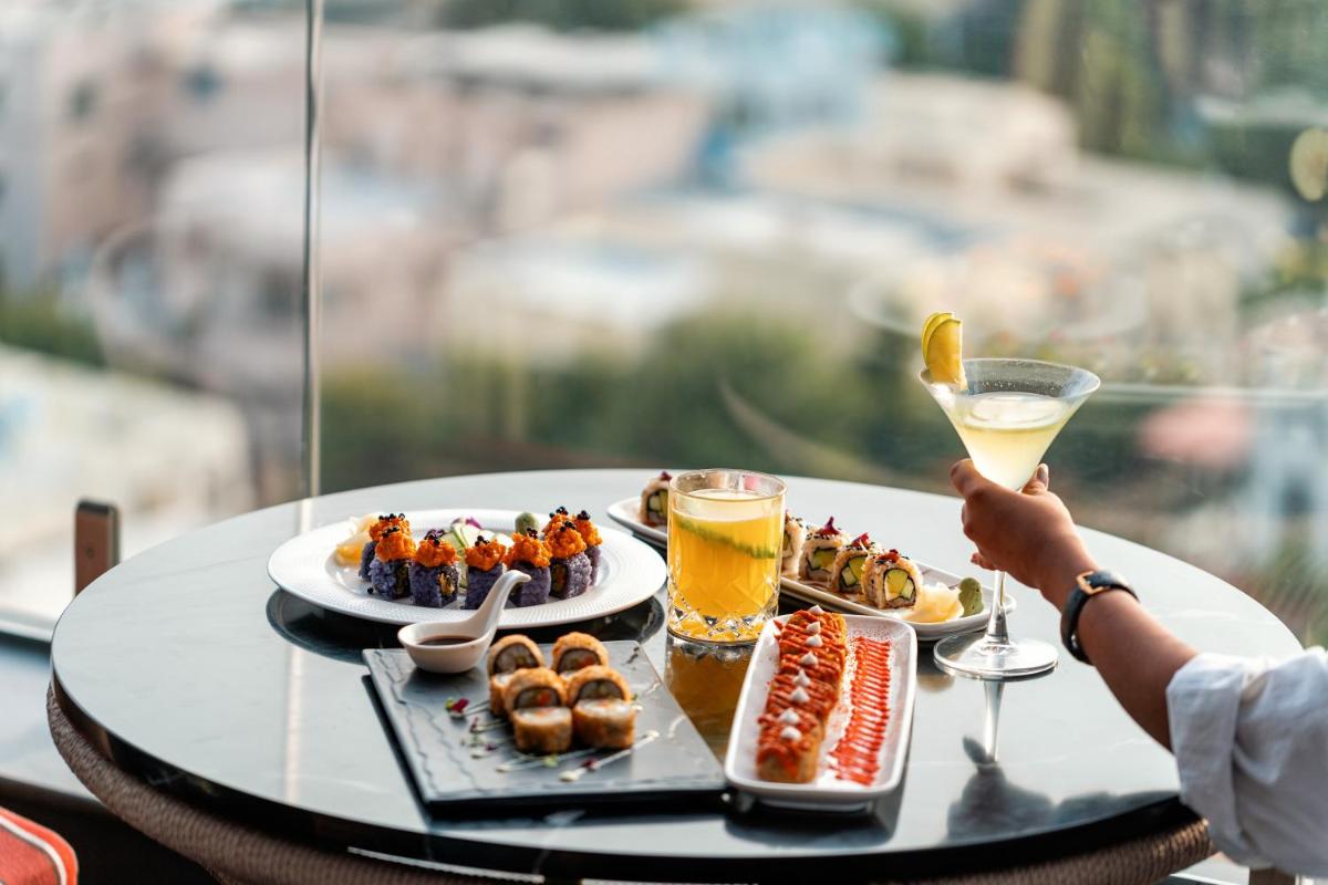 a tray of food on a table with drinks at Parallel Hotel Udaipur, a member of Radisson Individuals in Udaipur