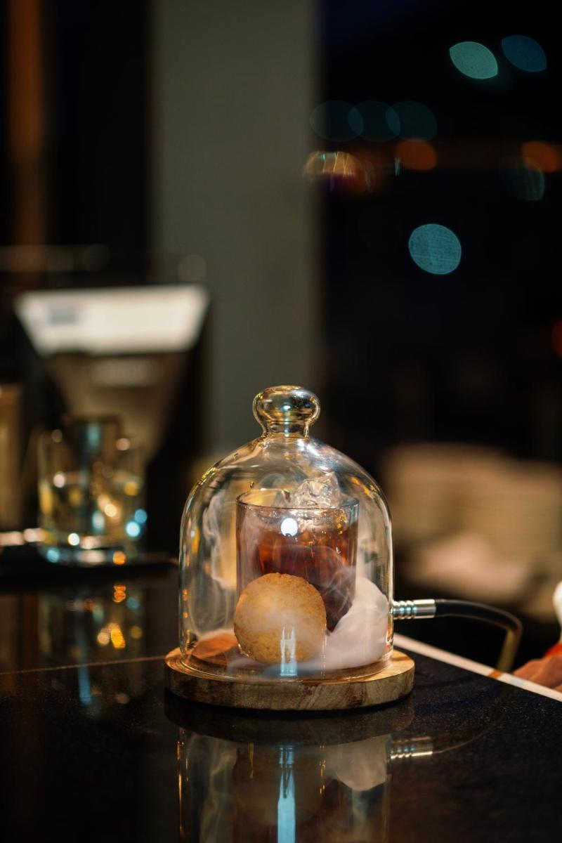 a glass jar with a cookie in it on a table at Parallel Hotel Udaipur, a member of Radisson Individuals in Udaipur