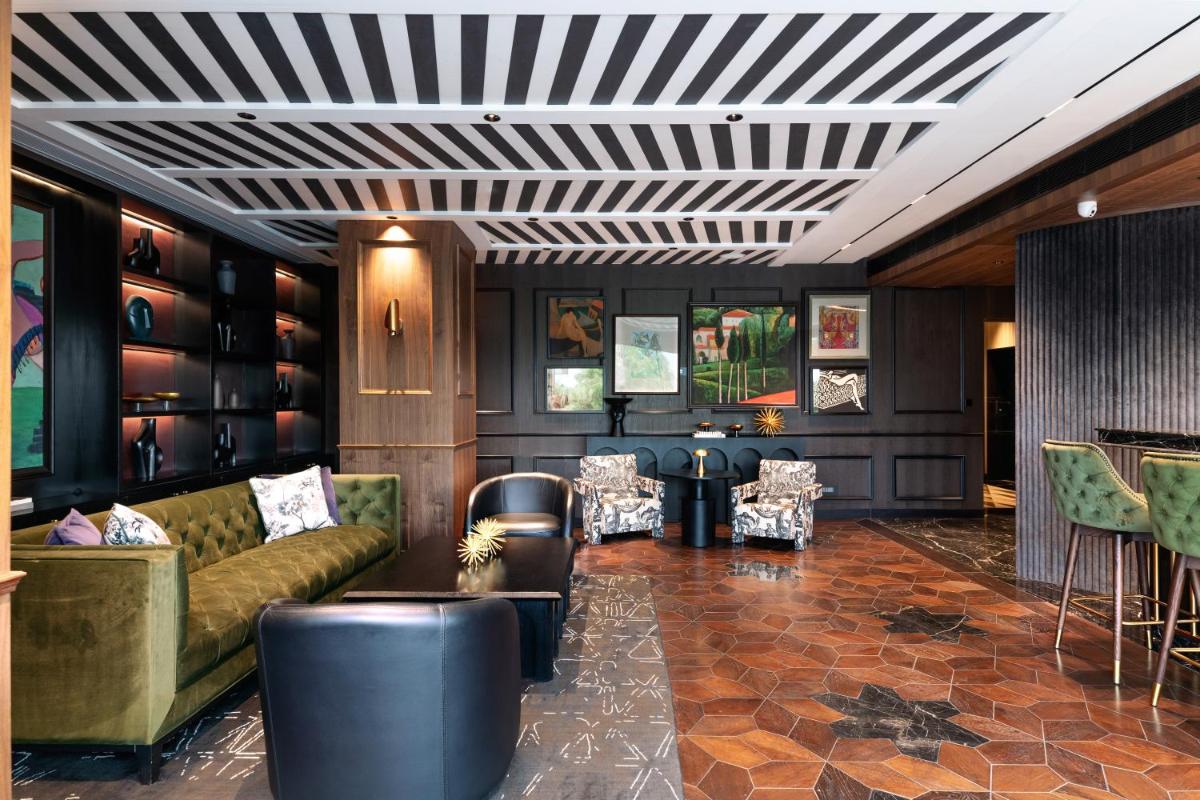 a living room with a couch and a table and chairs at Parallel Hotel Udaipur, a member of Radisson Individuals in Udaipur