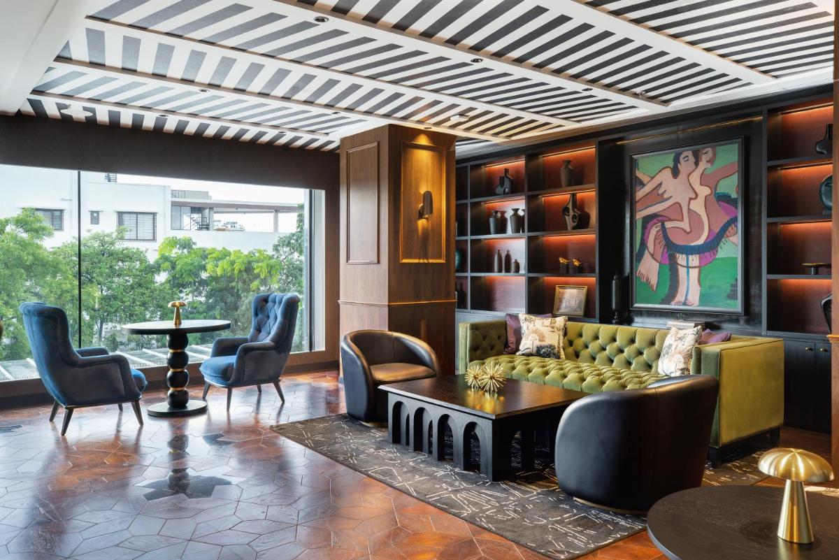 a lobby with a couch and chairs and a table at Parallel Hotel Udaipur, a member of Radisson Individuals in Udaipur
