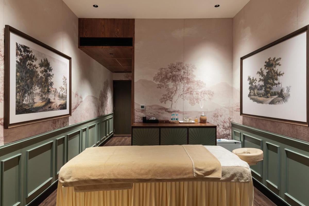 a bedroom with a bed and two pictures on the wall at Parallel Hotel Udaipur, a member of Radisson Individuals in Udaipur
