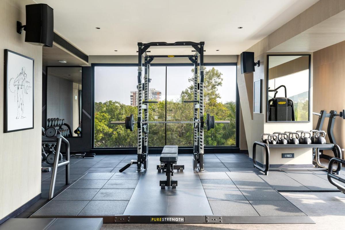 a gym with tread machines and a large window at Parallel Hotel Udaipur, a member of Radisson Individuals in Udaipur