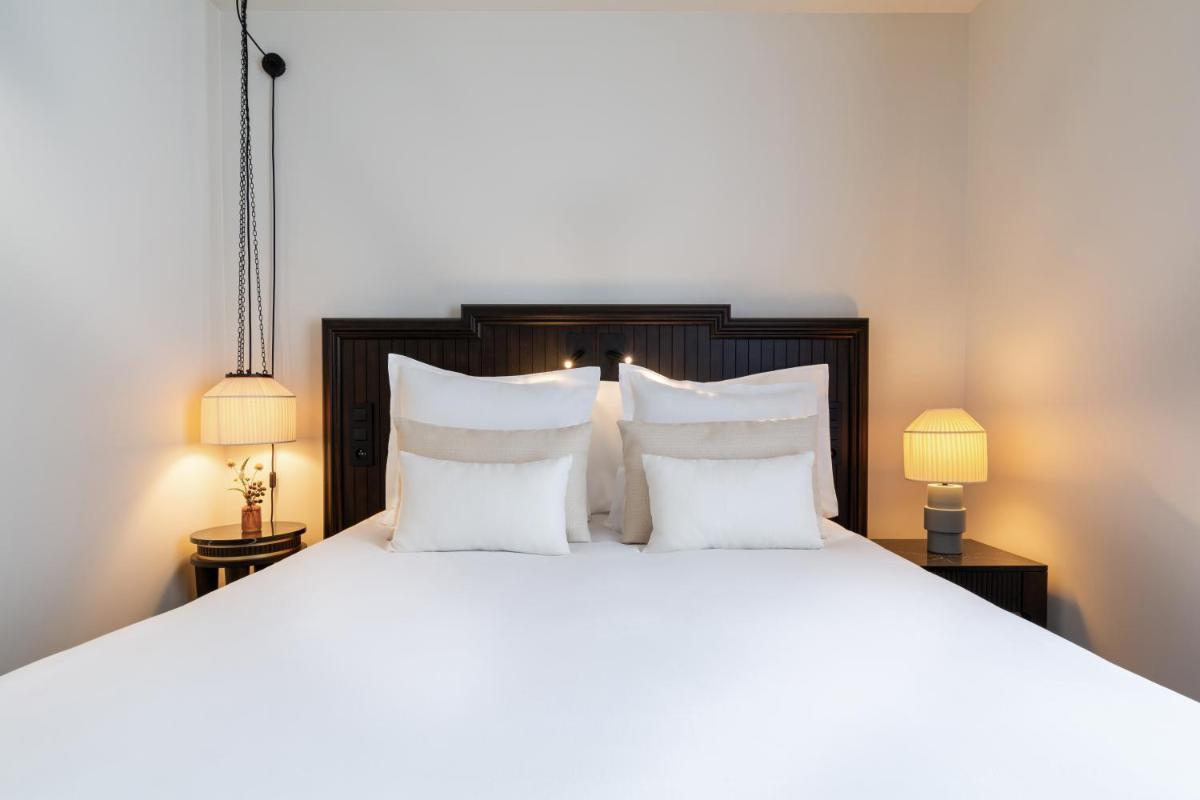 Un ou plusieurs lits dans un hébergement de l'établissement Hôtel & SPA Napoléon