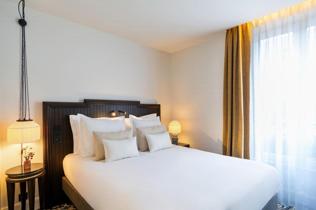 Un ou plusieurs lits dans un hébergement de l'établissement Hôtel & SPA Napoléon