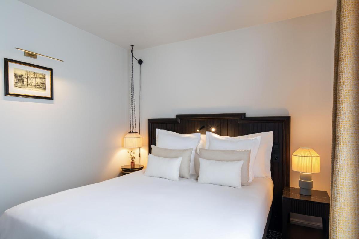 Un ou plusieurs lits dans un hébergement de l'établissement Hôtel & SPA Napoléon