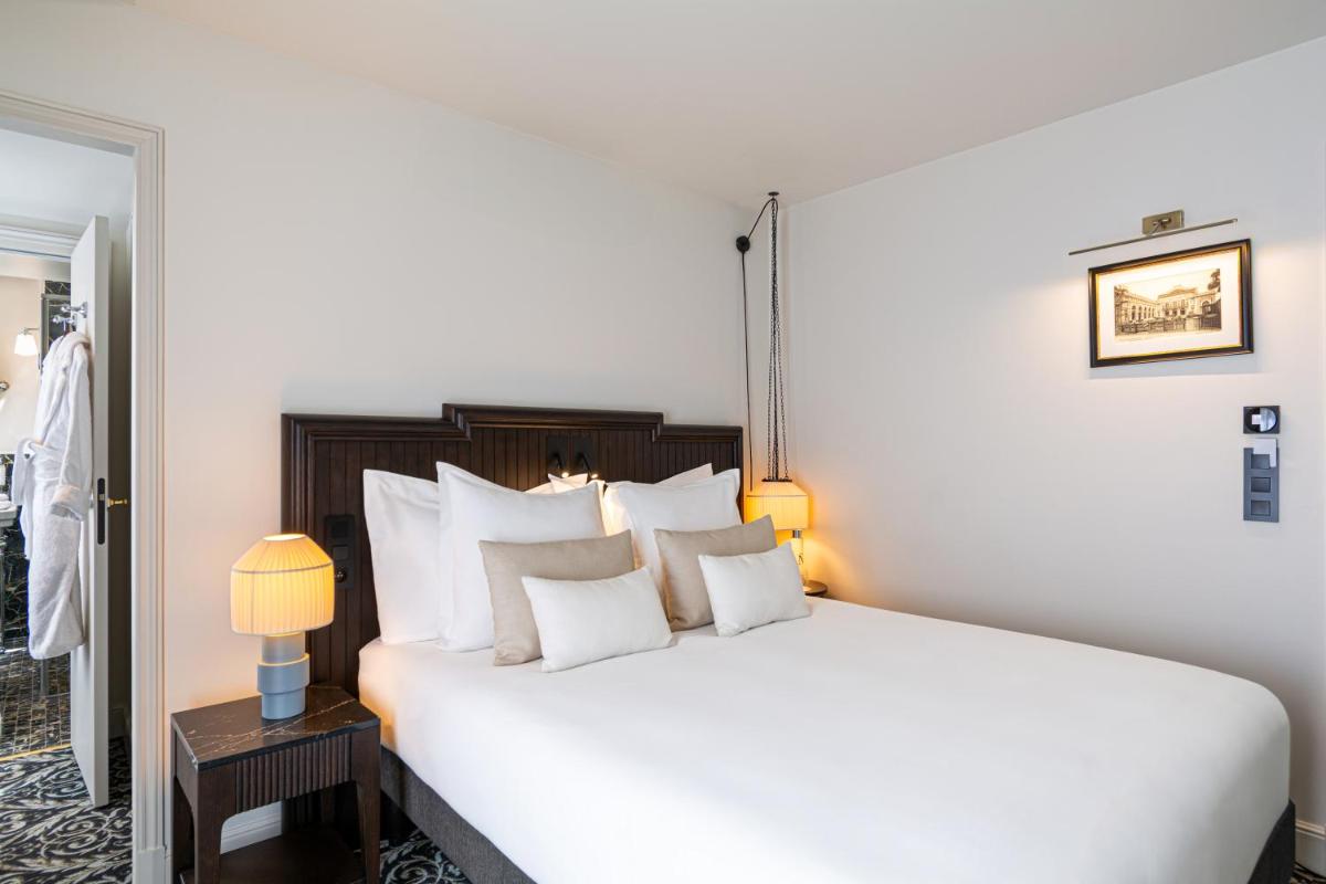 Un ou plusieurs lits dans un hébergement de l'établissement Hôtel & SPA Napoléon