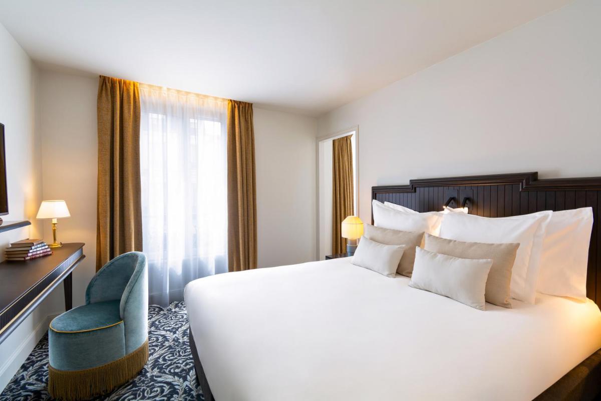 Un ou plusieurs lits dans un hébergement de l'établissement Hôtel & SPA Napoléon