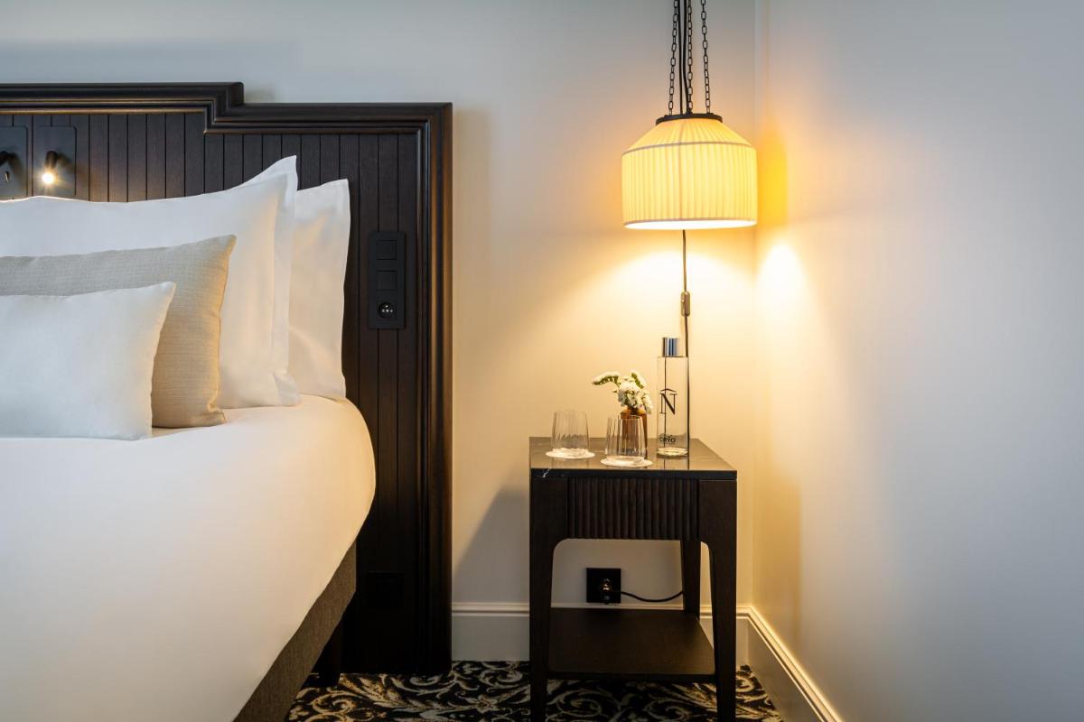 Un ou plusieurs lits dans un hébergement de l'établissement Hôtel & SPA Napoléon