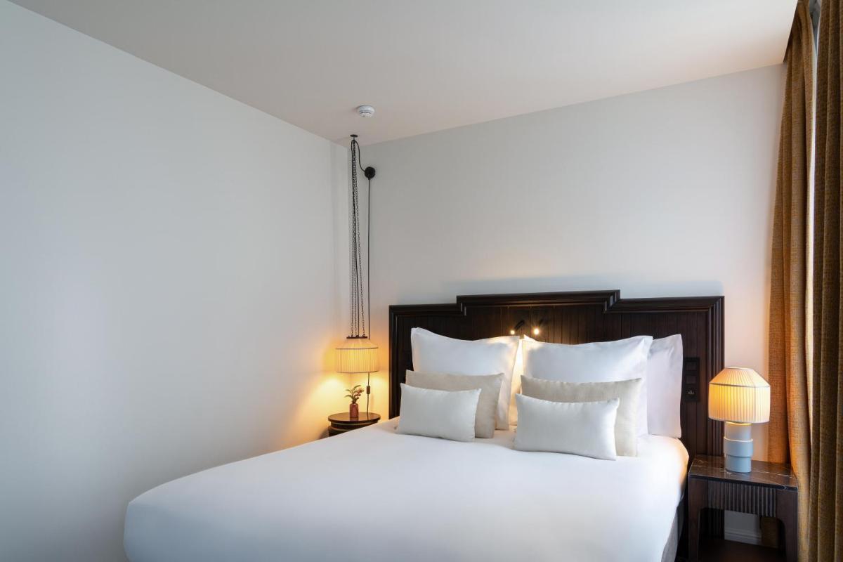 Un ou plusieurs lits dans un hébergement de l'établissement Hôtel & SPA Napoléon