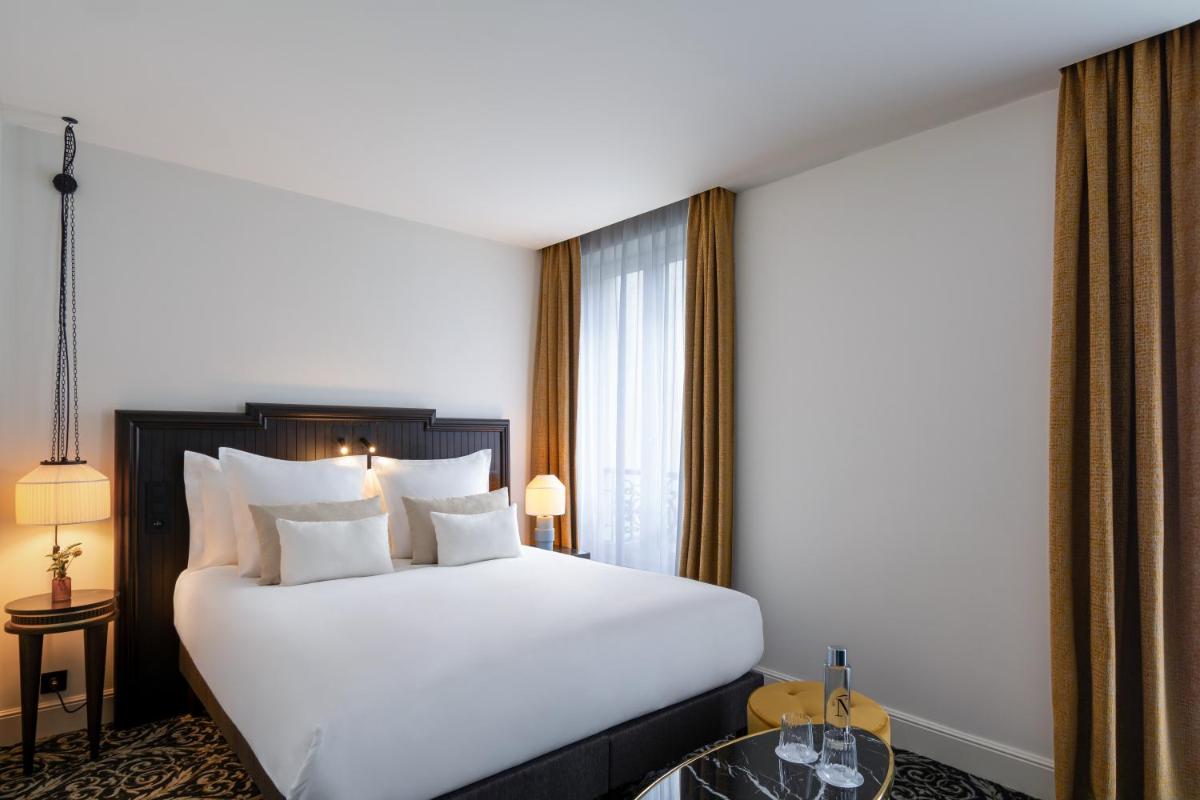 Un ou plusieurs lits dans un hébergement de l'établissement Hôtel & SPA Napoléon