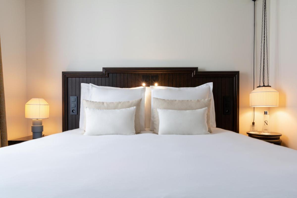 Un ou plusieurs lits dans un hébergement de l'établissement Hôtel & SPA Napoléon