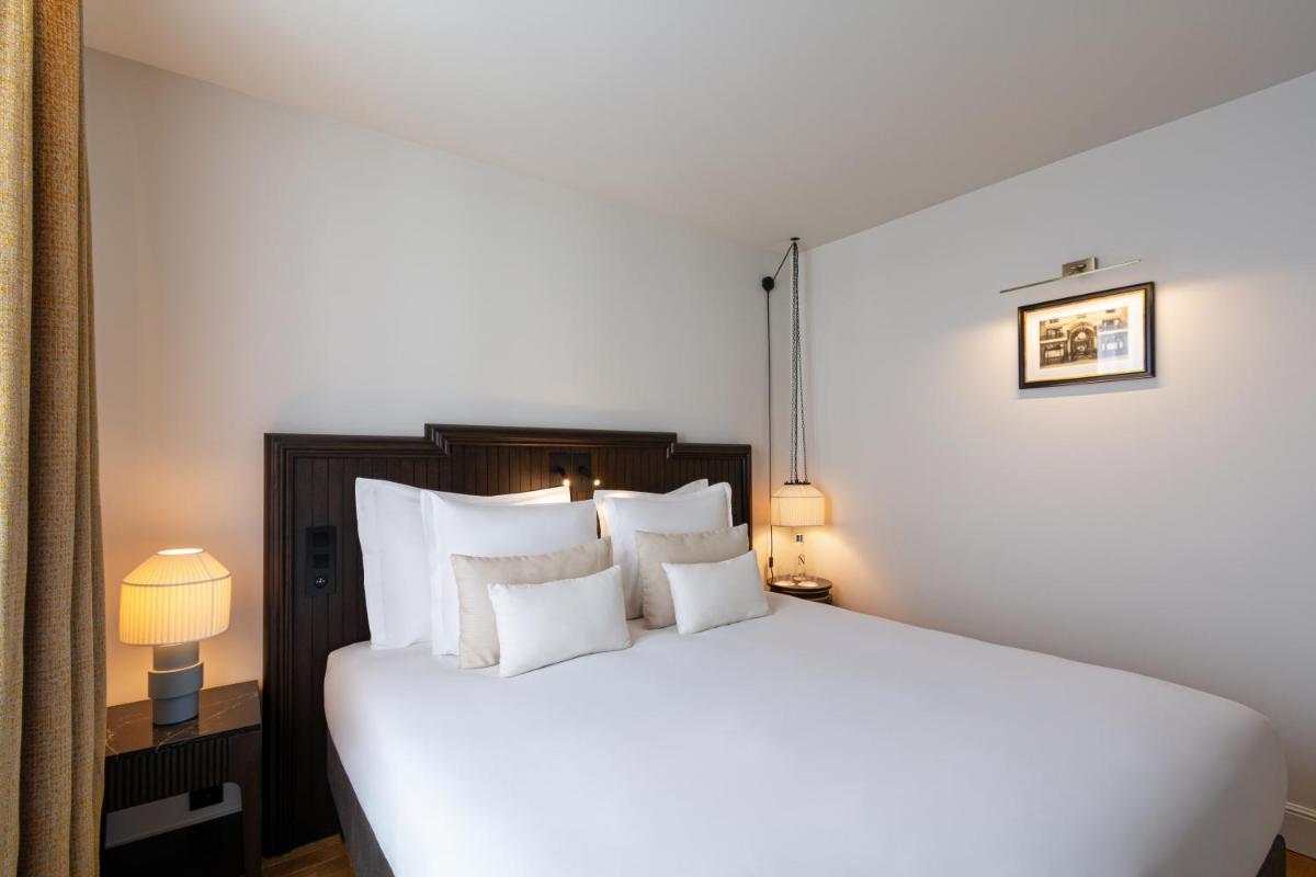 Un ou plusieurs lits dans un hébergement de l'établissement Hôtel & SPA Napoléon