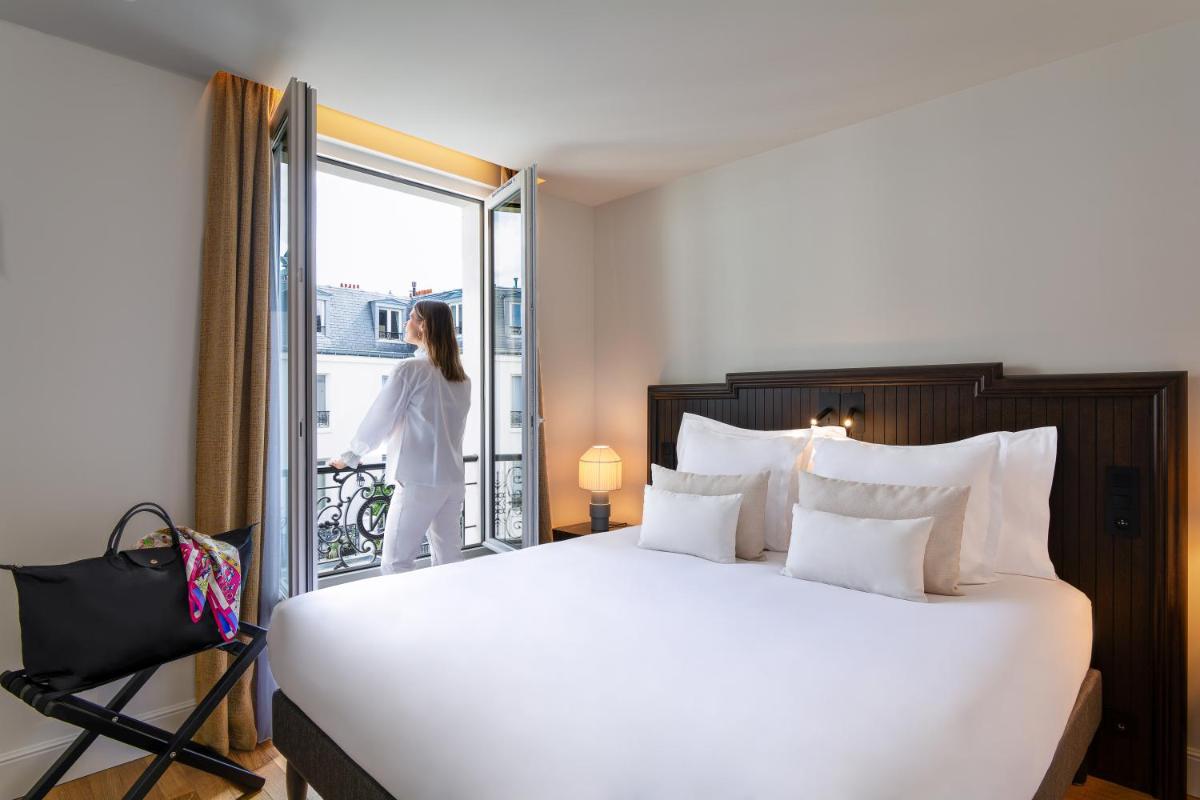 Un ou plusieurs lits dans un hébergement de l'établissement Hôtel & SPA Napoléon