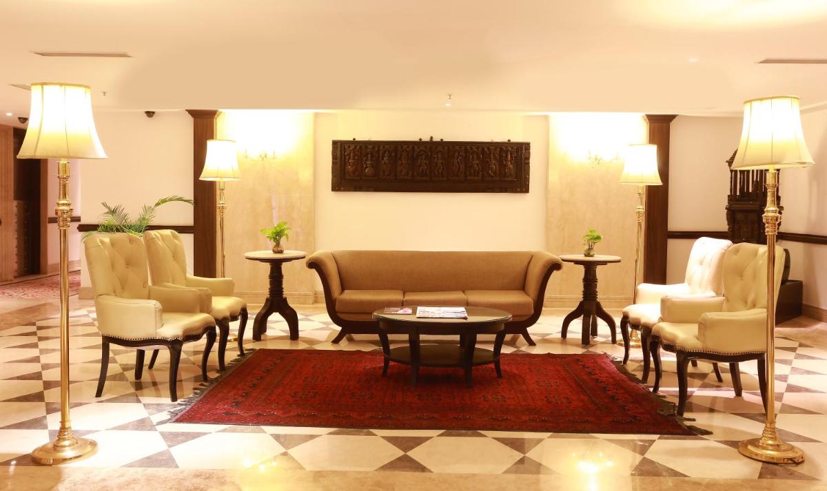 a lobby with chairs and a table in a room at The Ashok, New Delhi in New Delhi a lobby with chairs and a table in a room at The Ashok, New Delhi in New Delhi