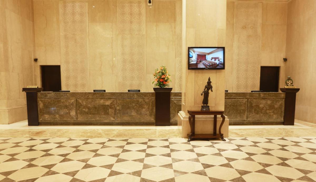 a lobby with a television in a building with a checkered floor at The Ashok, New Delhi in New Delhi a lobby with a television in a building with a checkered floor at The Ashok, New Delhi in New Delhi