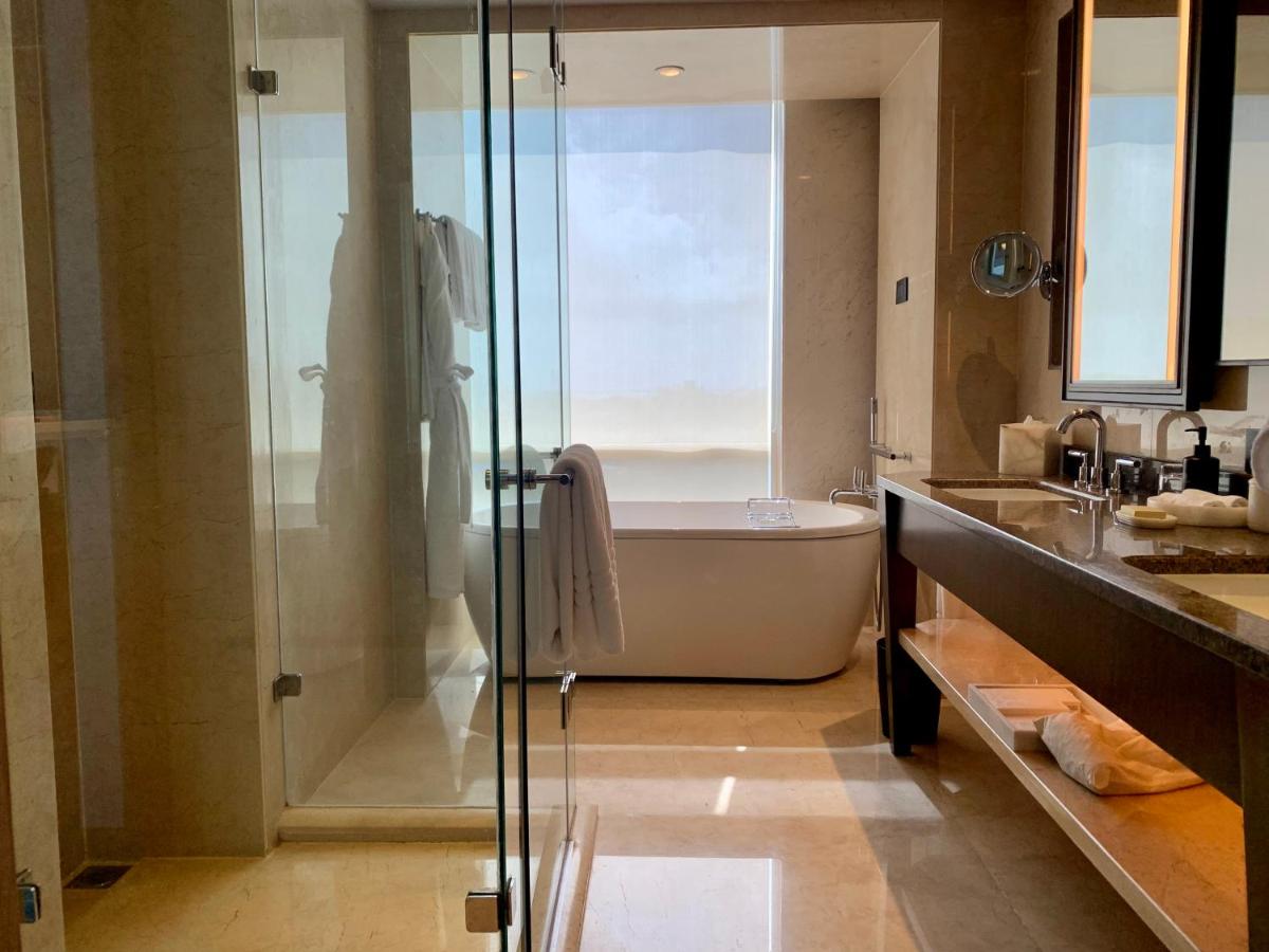 a bathroom with a tub and a shower and a sink at Four Seasons Hotel Mumbai in Mumbai