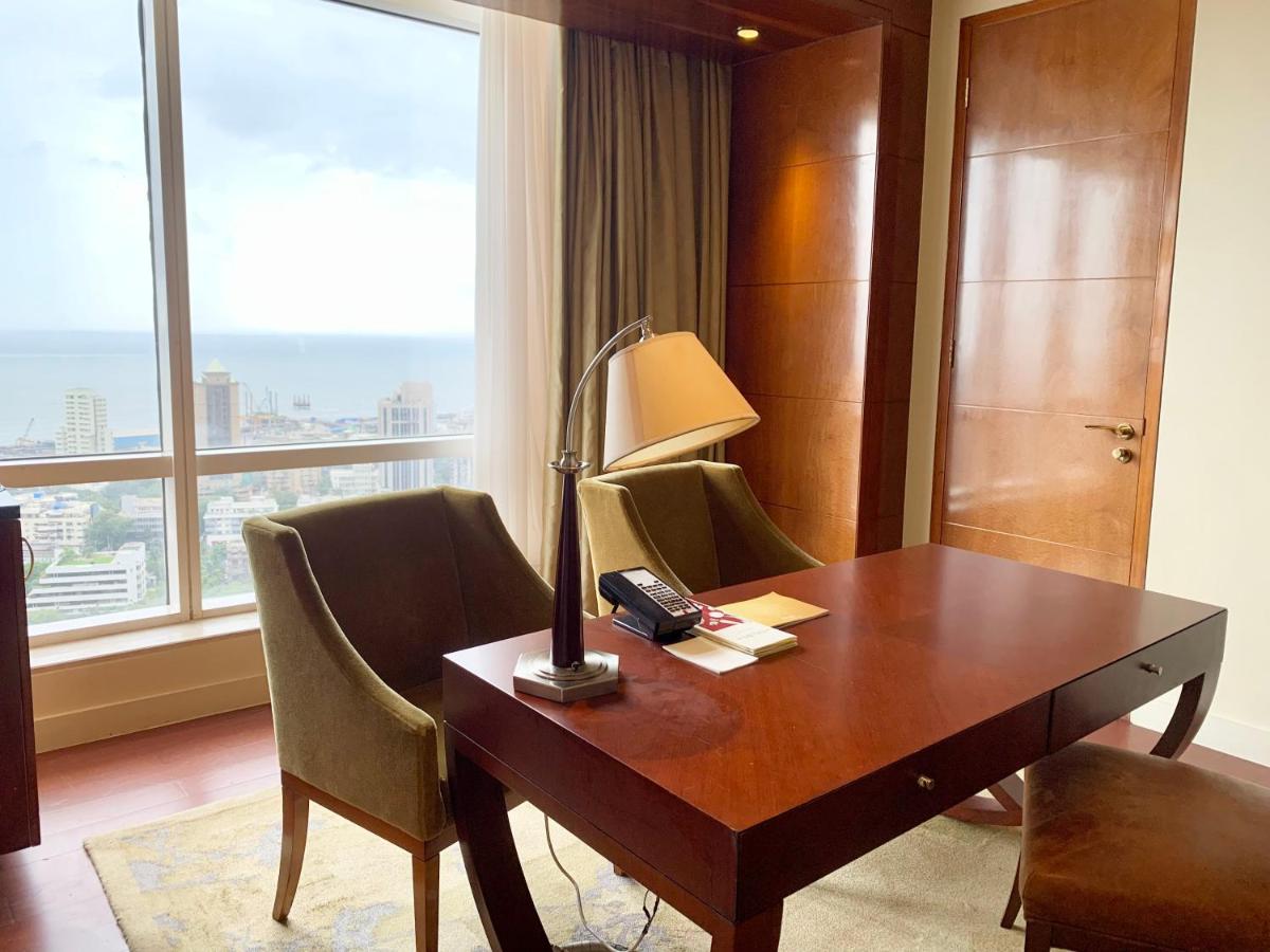 a desk with a lamp and chairs in a hotel room at Four Seasons Hotel Mumbai in Mumbai