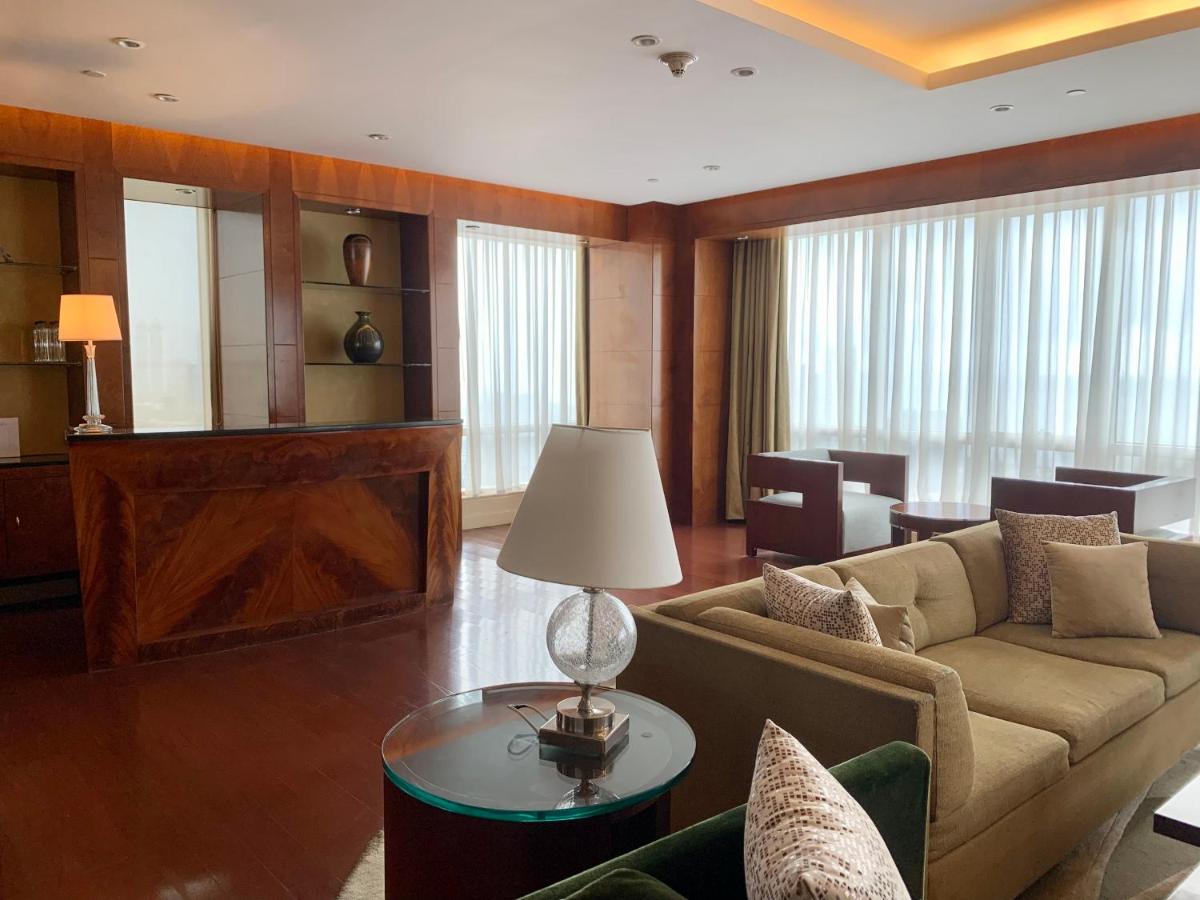 a living room with a couch and a table at Four Seasons Hotel Mumbai in Mumbai