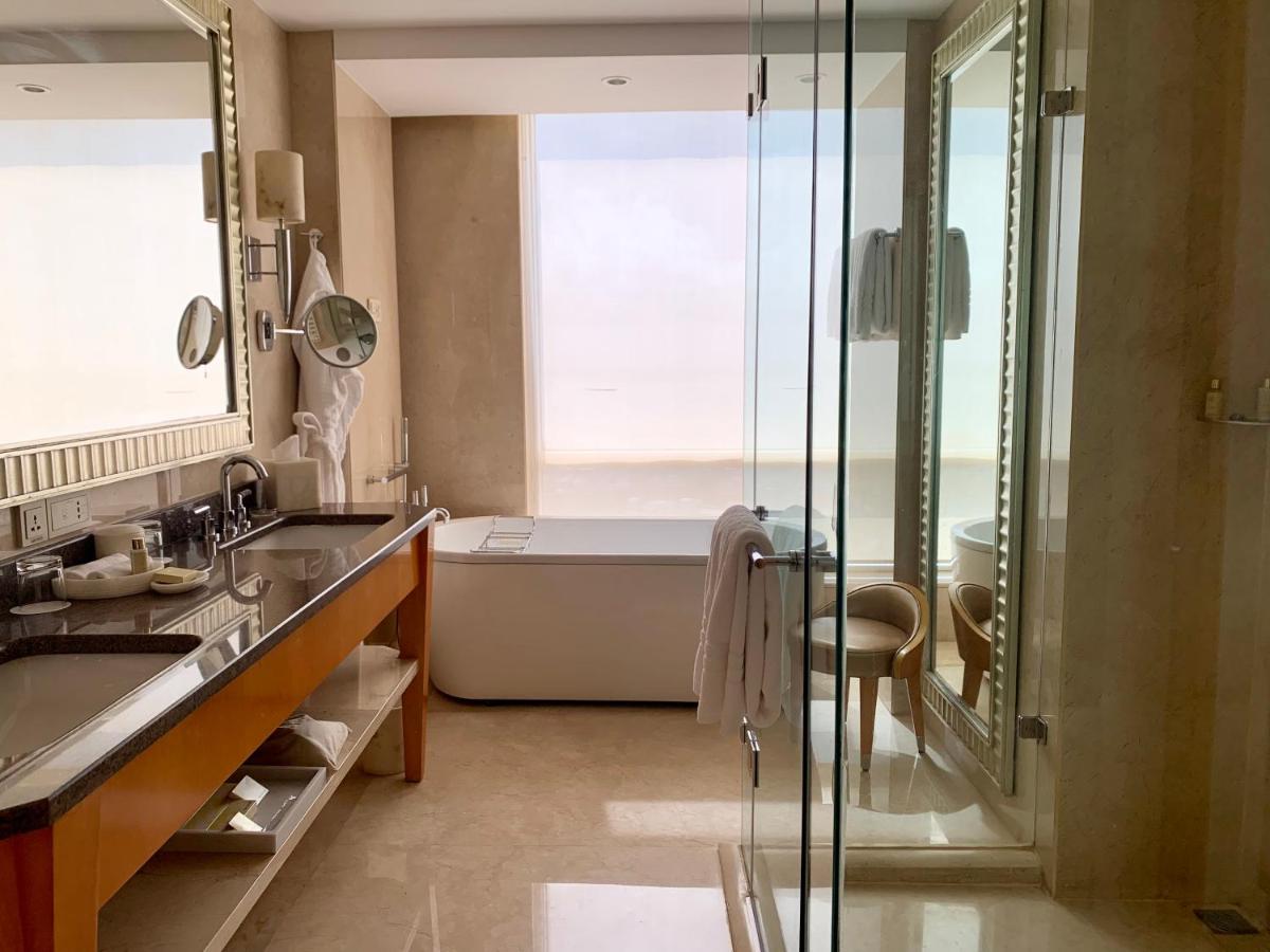 a bathroom with a tub and a sink and a shower at Four Seasons Hotel Mumbai in Mumbai