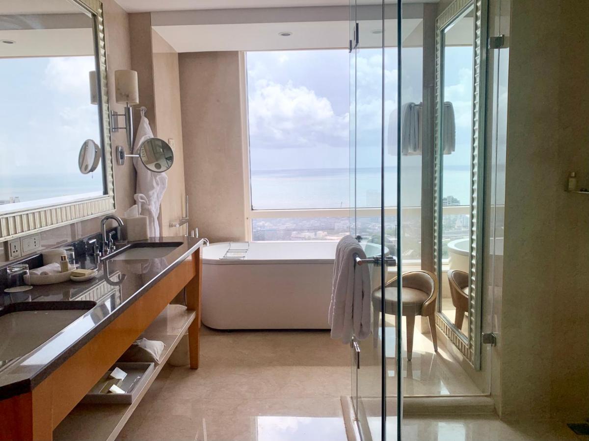 a bathroom with a tub and a shower with a window at Four Seasons Hotel Mumbai in Mumbai