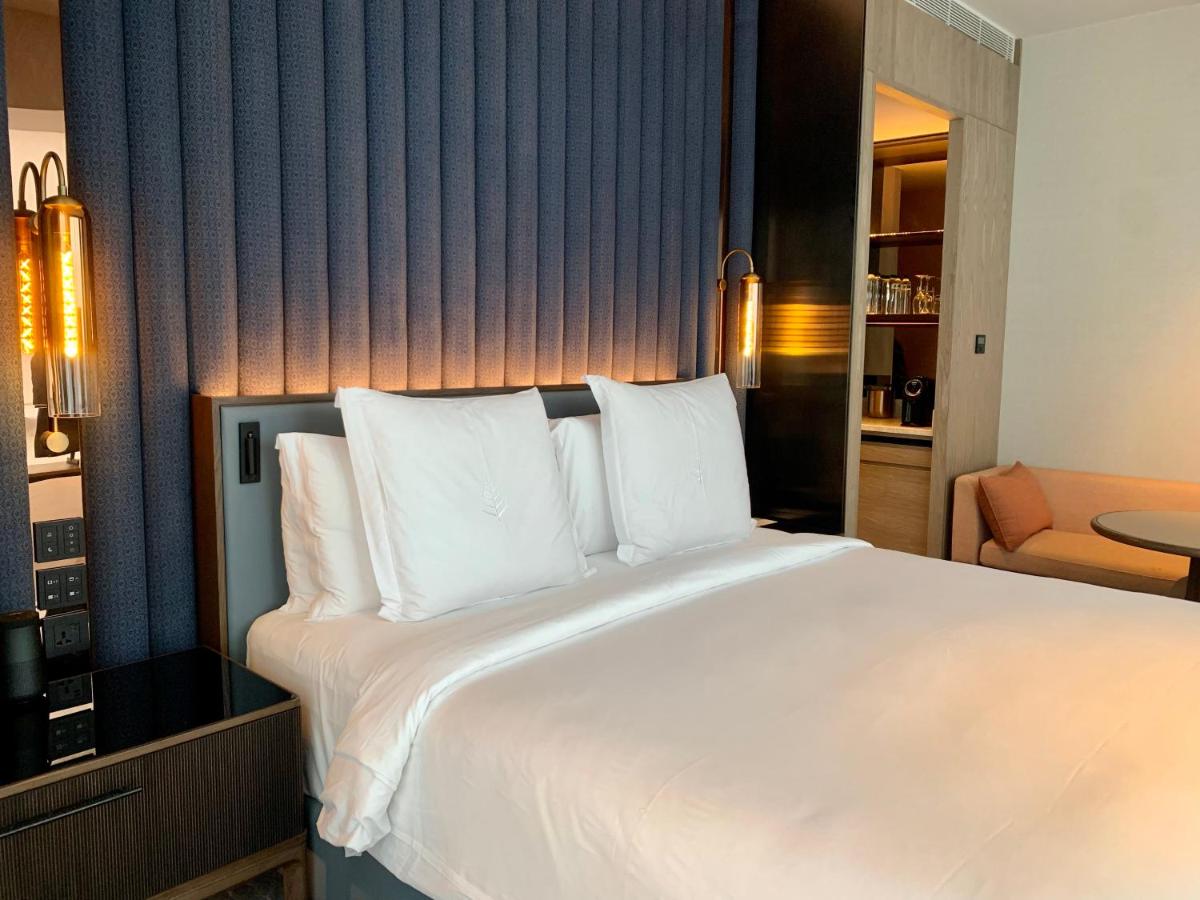 a large white bed in a hotel room at Four Seasons Hotel Mumbai in Mumbai
