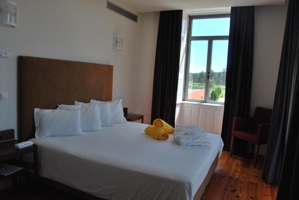 Uma cama ou camas num quarto em Hotel Quinta da Cruz & SPA