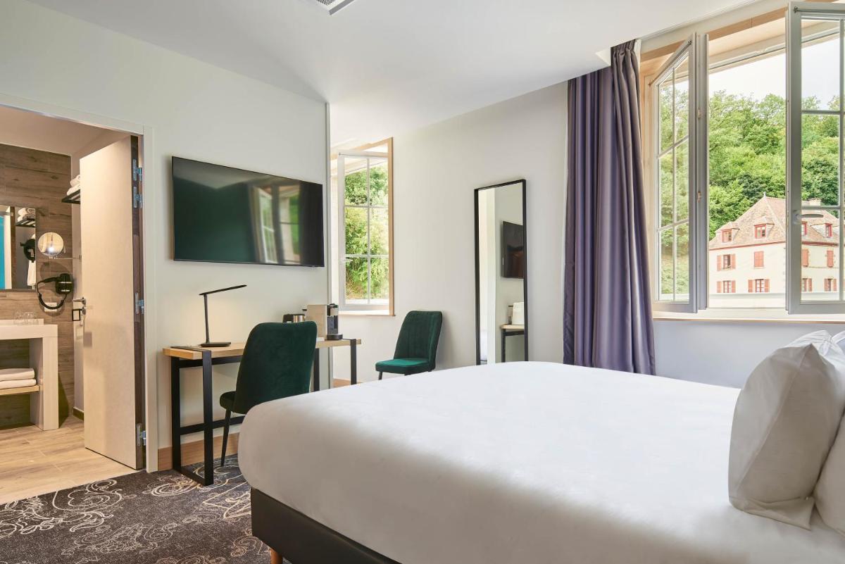 Un ou plusieurs lits dans un hébergement de l'établissement Le Grand Hôtel, The Originals Relais