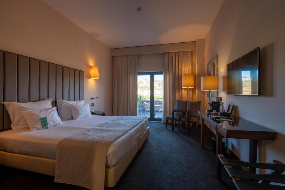 Uma cama ou camas num quarto em Vila Gale Collection Douro