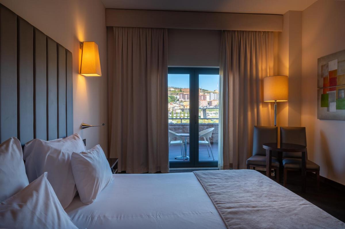 Uma cama ou camas num quarto em Vila Gale Collection Douro