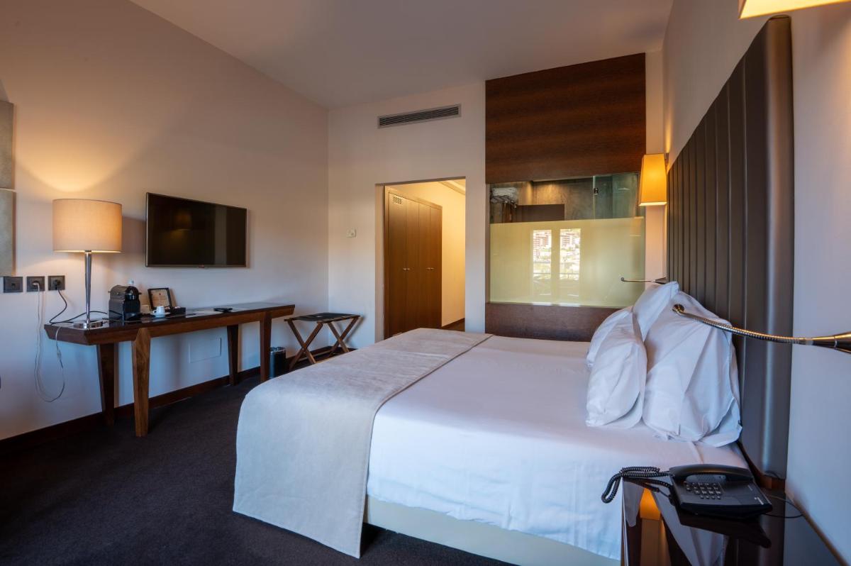 Uma cama ou camas num quarto em Vila Gale Collection Douro
