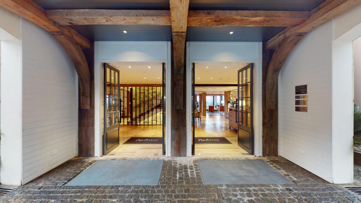 an open hallway of a building with glass doors at Radisson Hotel Shimla in Shimla