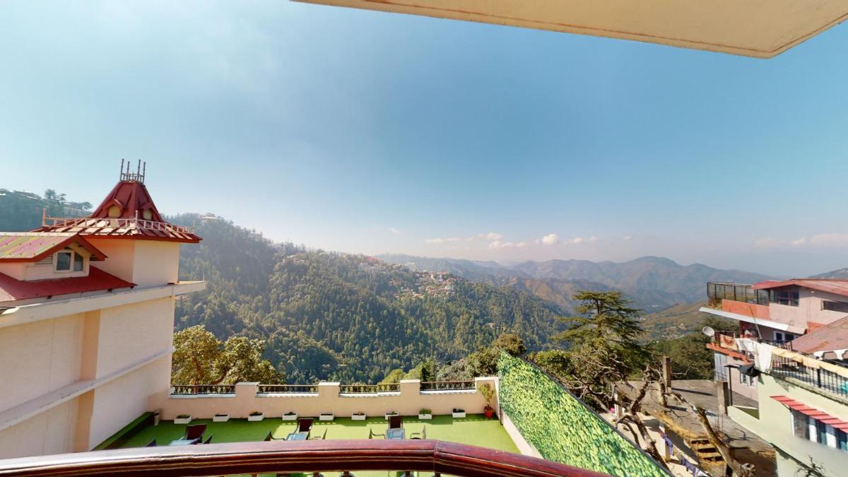 a view of the mountains from the balcony of a building at Radisson Hotel Shimla in Shimla