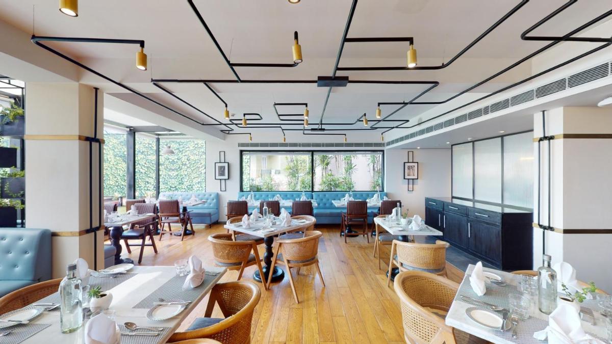 a dining room with tables and chairs at Radisson Hotel Shimla in Shimla