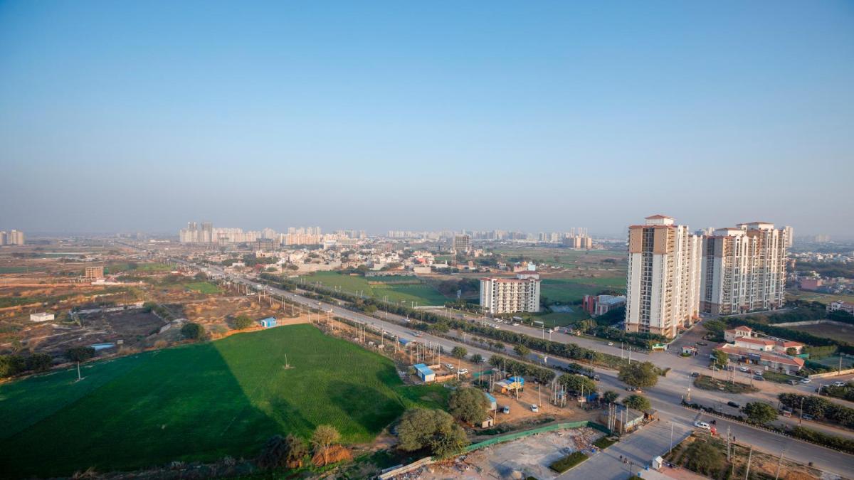 an aerial view of a city with tall buildings at Holiday Inn Gurugram Sector 90 by IHG in Gurgaon