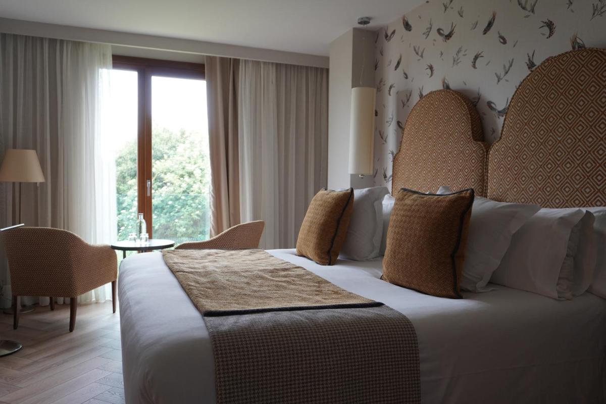 Cama o camas de una habitación en ARTIEM Asturias