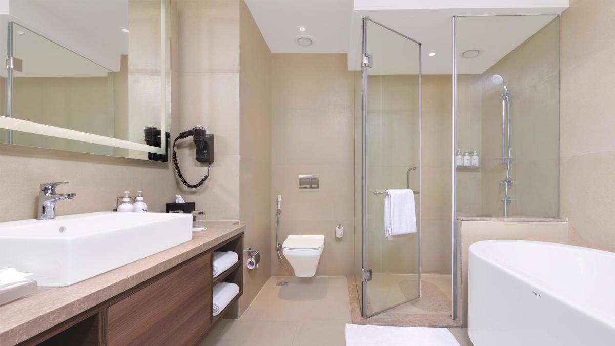 a bathroom with a sink toilet and a shower at Holiday Inn Gurugram Sector 90 by IHG in Gurgaon