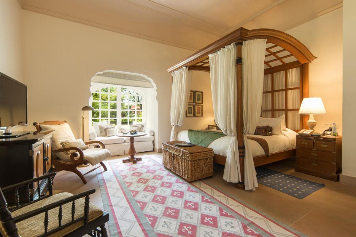 a bedroom with a canopy bed and a window at The Oberoi Rajvilas Jaipur in Jaipur