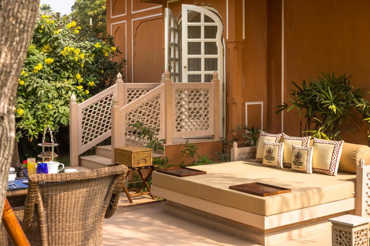 a patio with a couch and chairs on a porch at The Oberoi Rajvilas Jaipur in Jaipur