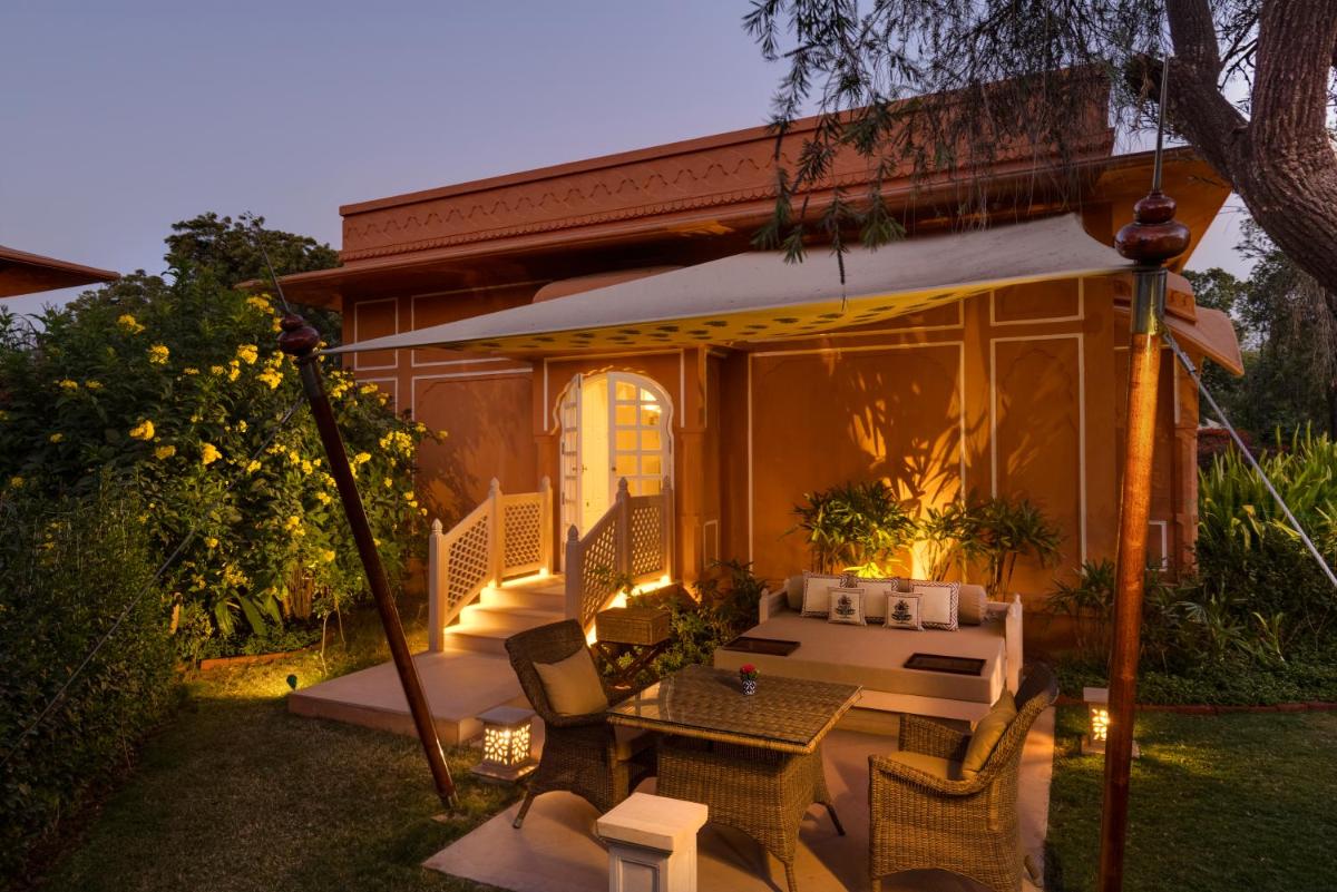 a patio of a house with a table and chairs at The Oberoi Rajvilas Jaipur in Jaipur