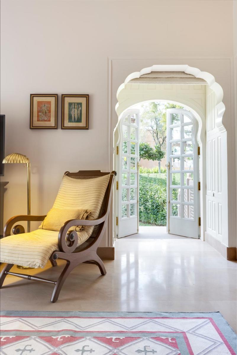 an archway leading into a living room with a chair at The Oberoi Rajvilas Jaipur in Jaipur