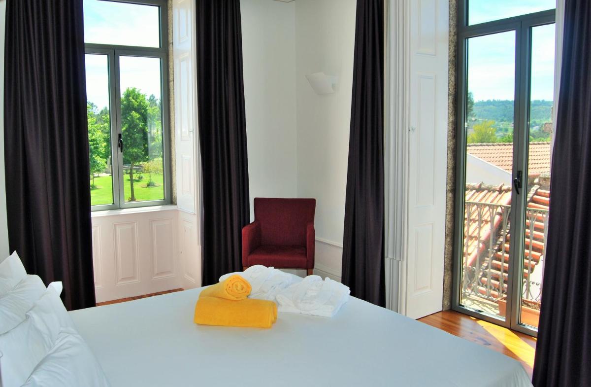 Uma cama ou camas num quarto em Hotel Quinta da Cruz & SPA