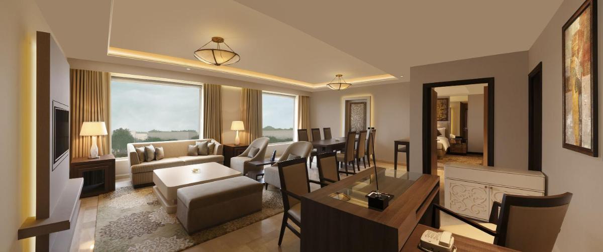 a living room with a couch and a table at DoubleTree by Hilton Agra in Agra